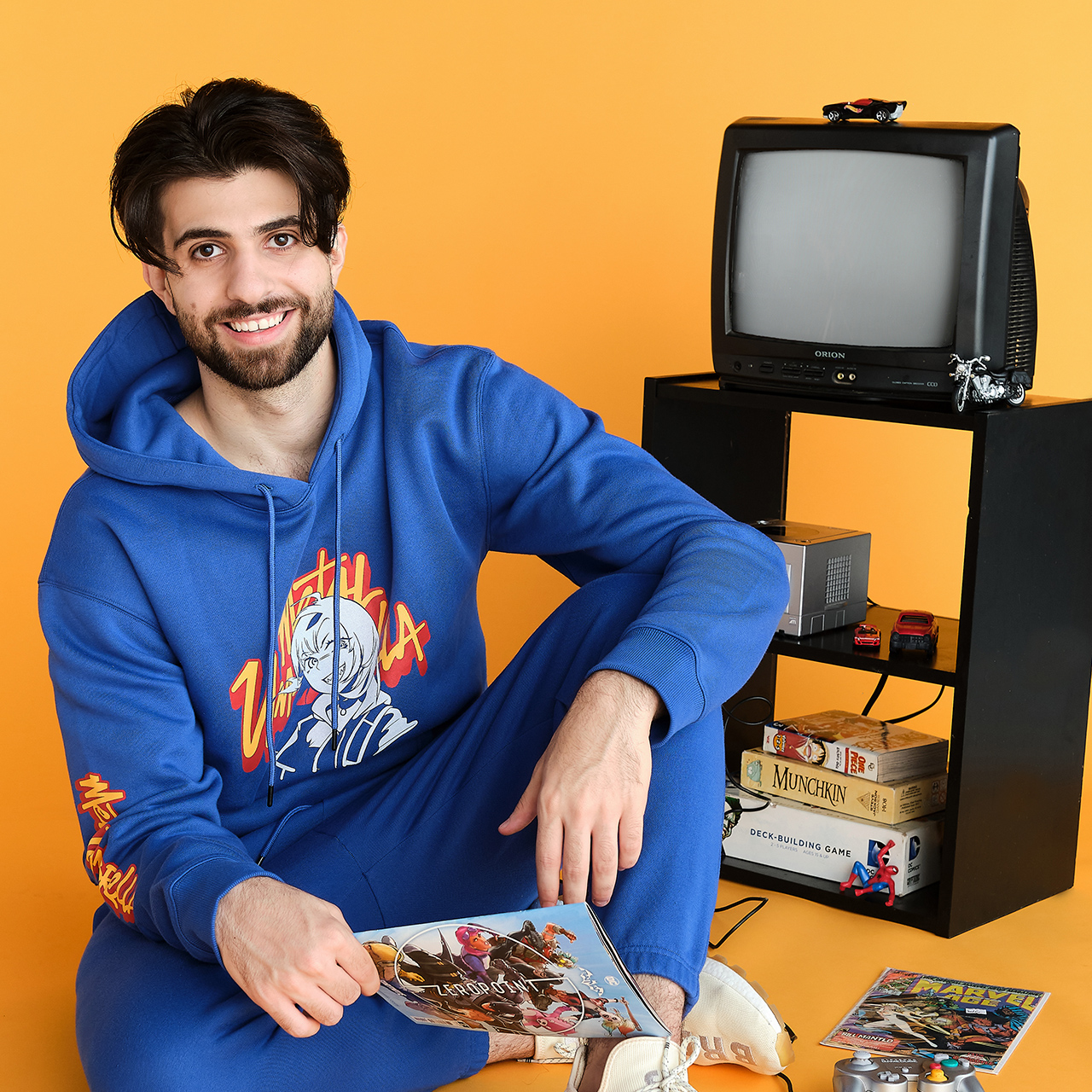 Man in metal umbrella hoodie with game console